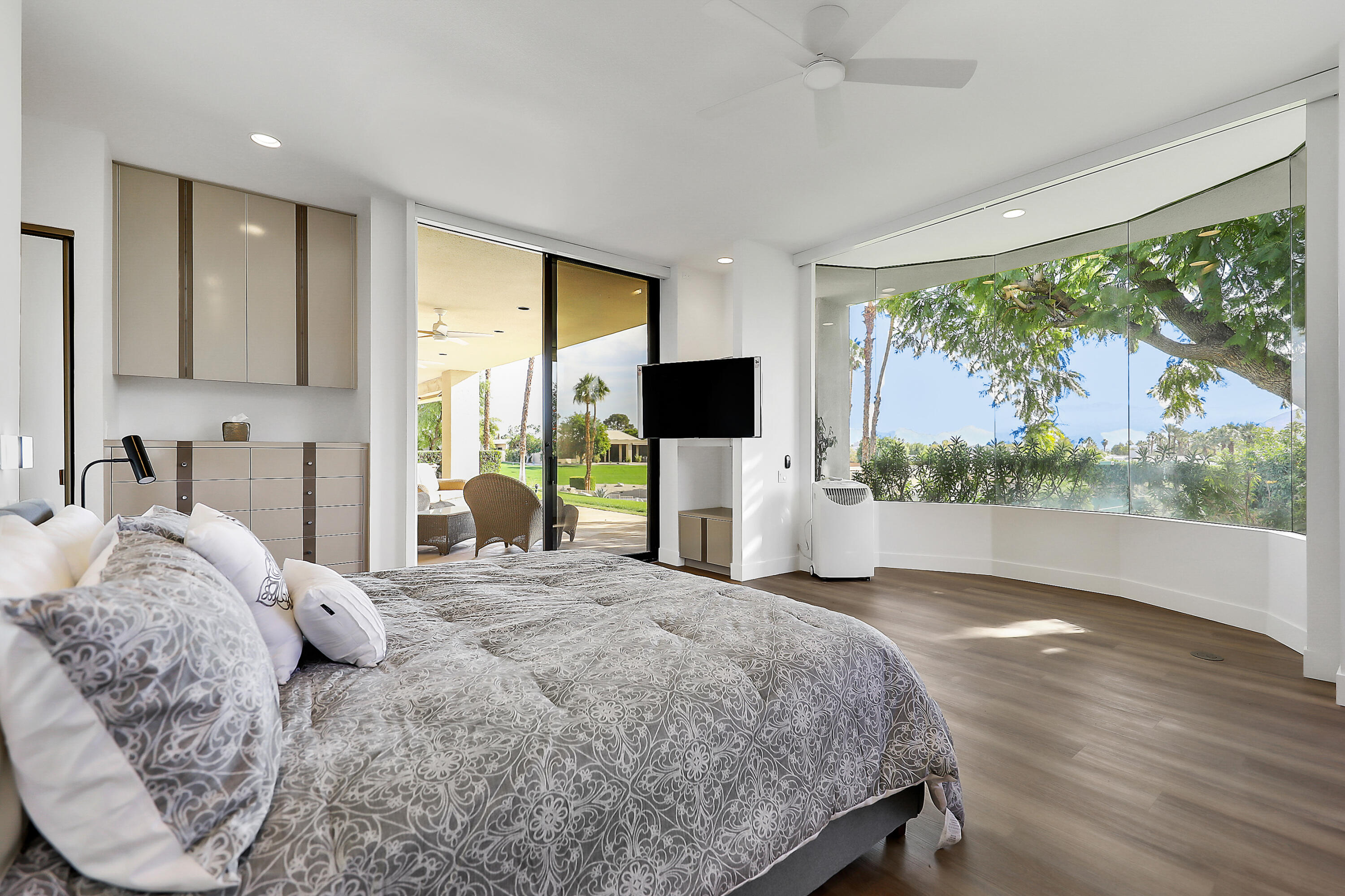 71000 Los Altos Court Rancho Mirage, CA 92270 - Photo 24 of 46 a bedroom with a large bed and a flat tv screen on dresser