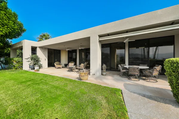 a view of a backyard with sitting area
