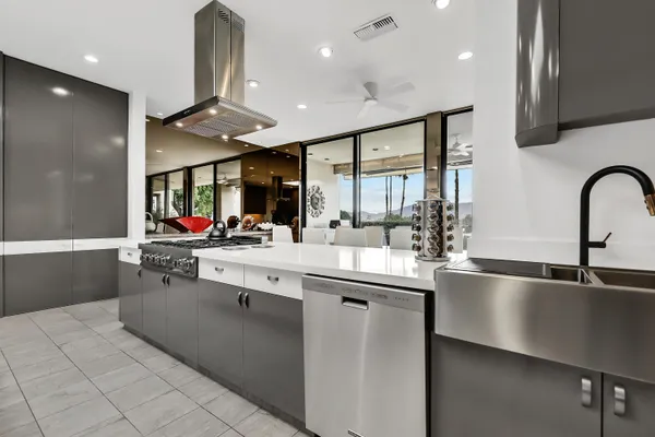 a kitchen with stainless steel appliances granite countertop a sink and a refrigerator