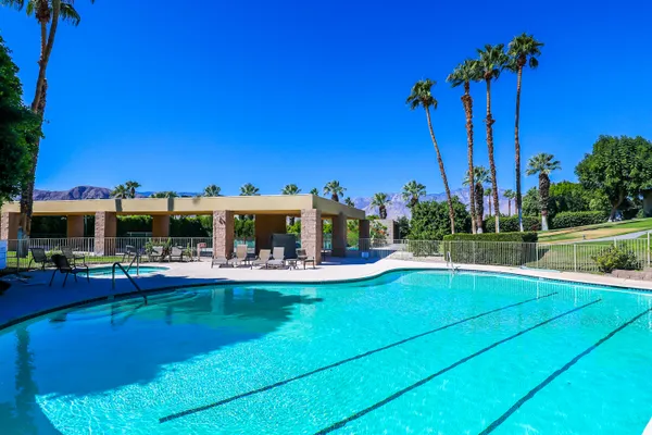 a view of a swimming pool with a table and chairs