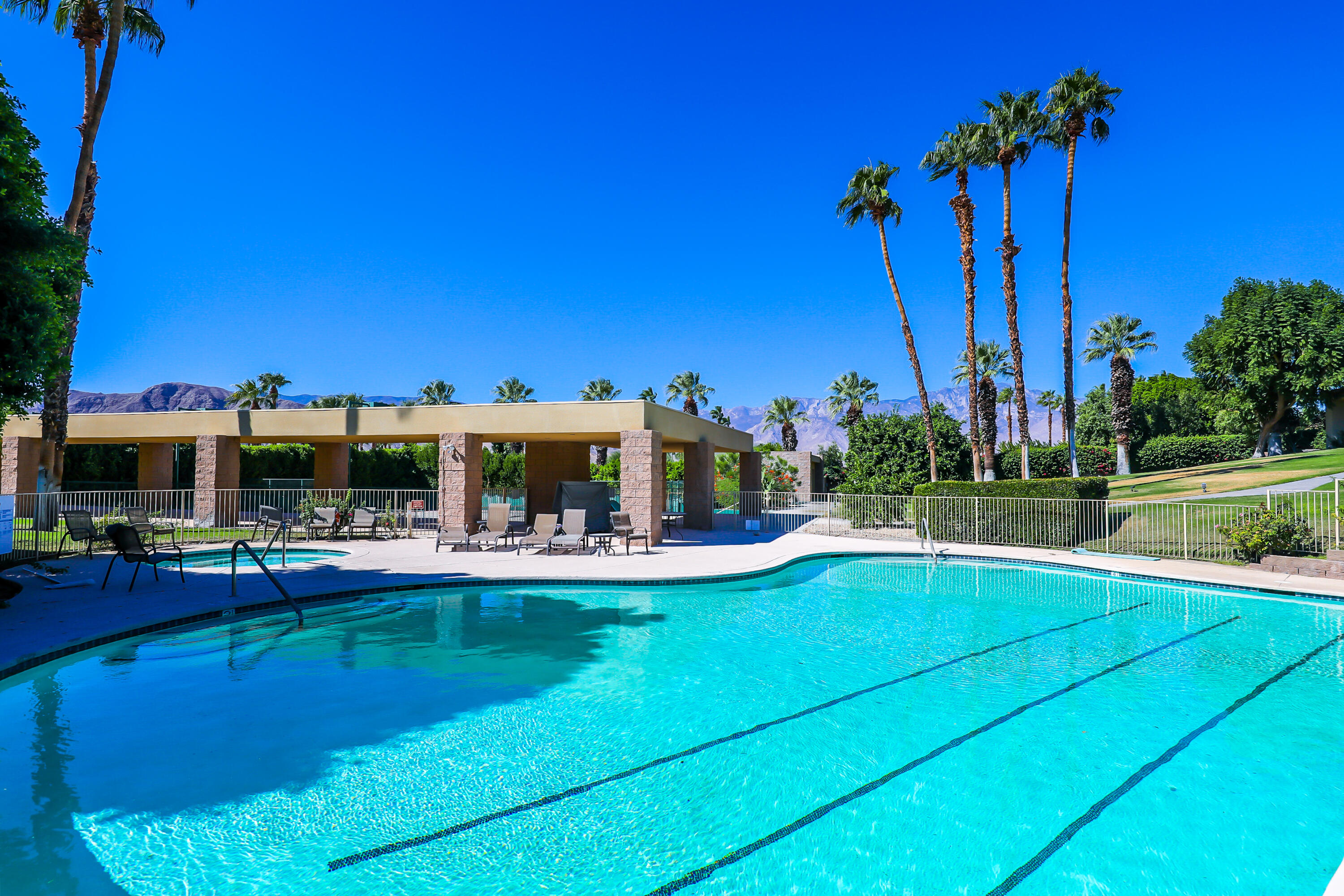71000 Los Altos Court Rancho Mirage, CA 92270 - Photo 44 of 46 a view of a swimming pool with a table and chairs
