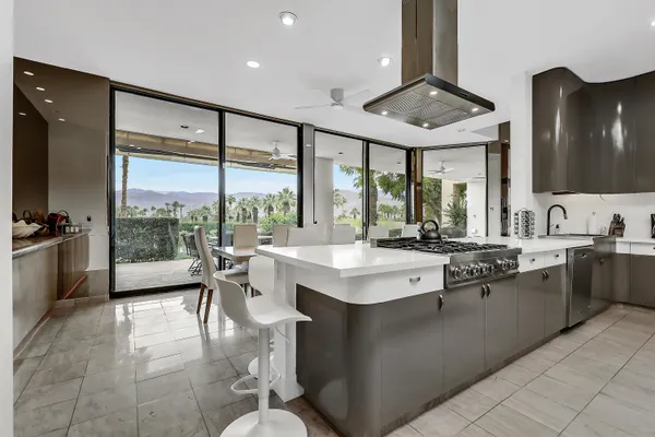 a kitchen with a sink and large windows