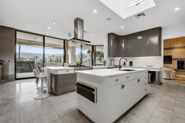 a large white kitchen with a large window