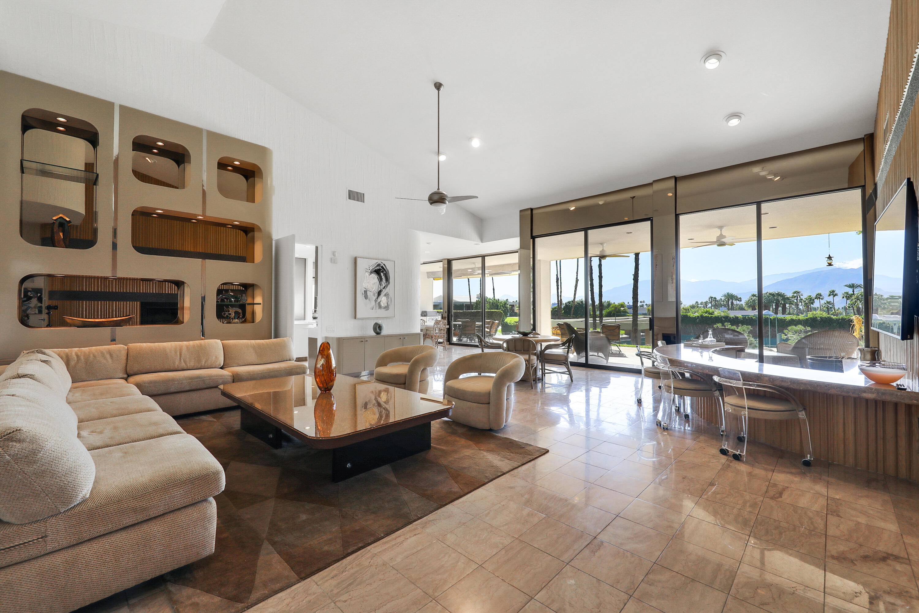 71000 Los Altos Court Rancho Mirage, CA 92270 - Photo 9 of 46 a living room with fireplace furniture and a large window