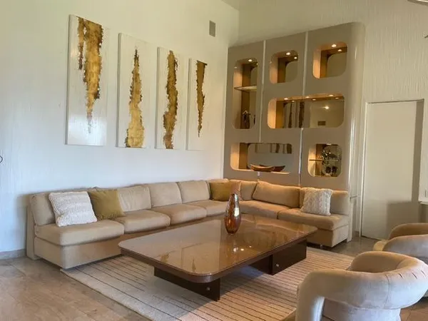 a living room with furniture and a large mirror