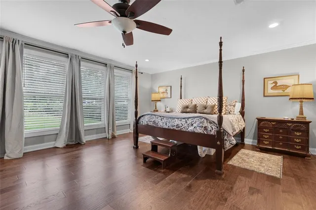 a bedroom with a bed closet and wooden floor