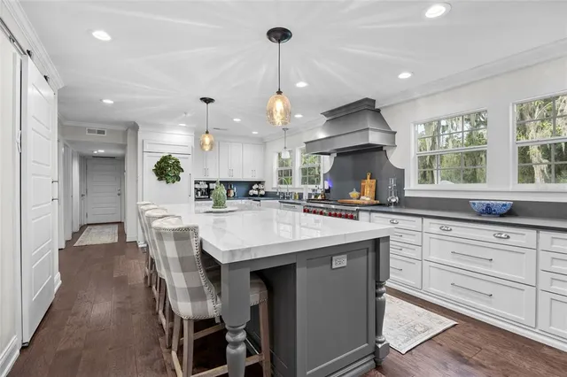 a kitchen with granite countertop wooden cabinets and white appliances