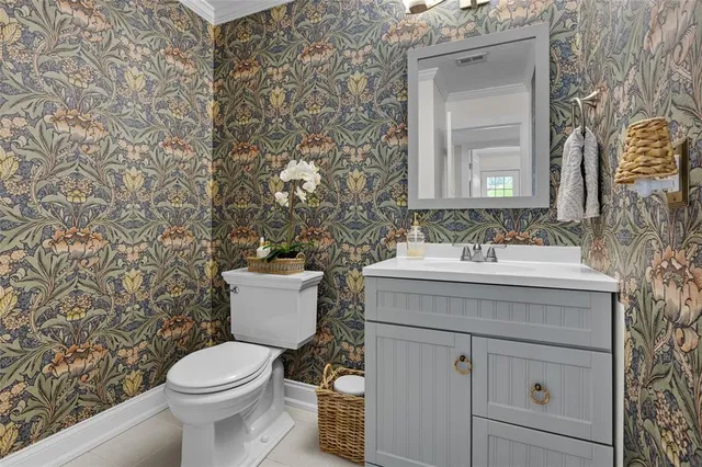 a bathroom with a sink toilet and a mirror