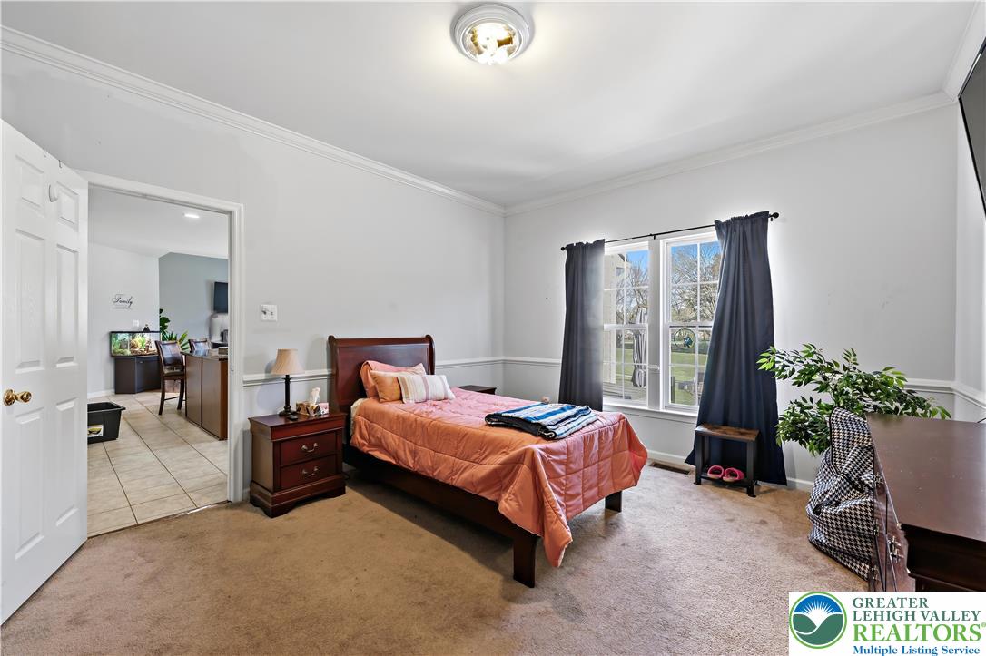 130 Lower Way Road Easton, PA 18045 - Photo 34 of 56 a bedroom with a bed and potted plant