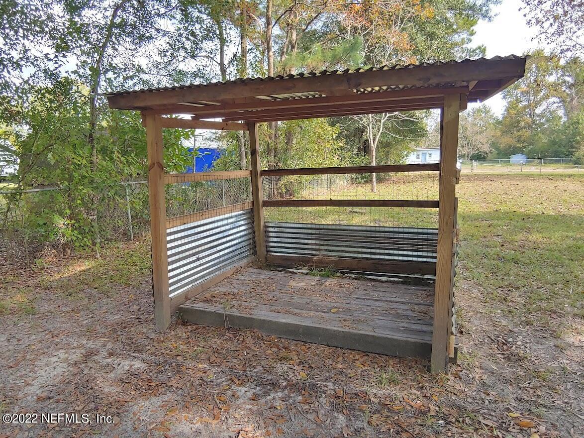54143 Jeannie Road Callahan, FL 32011 - Photo 35 of 36 a view of a backyard with large trees and a small yard