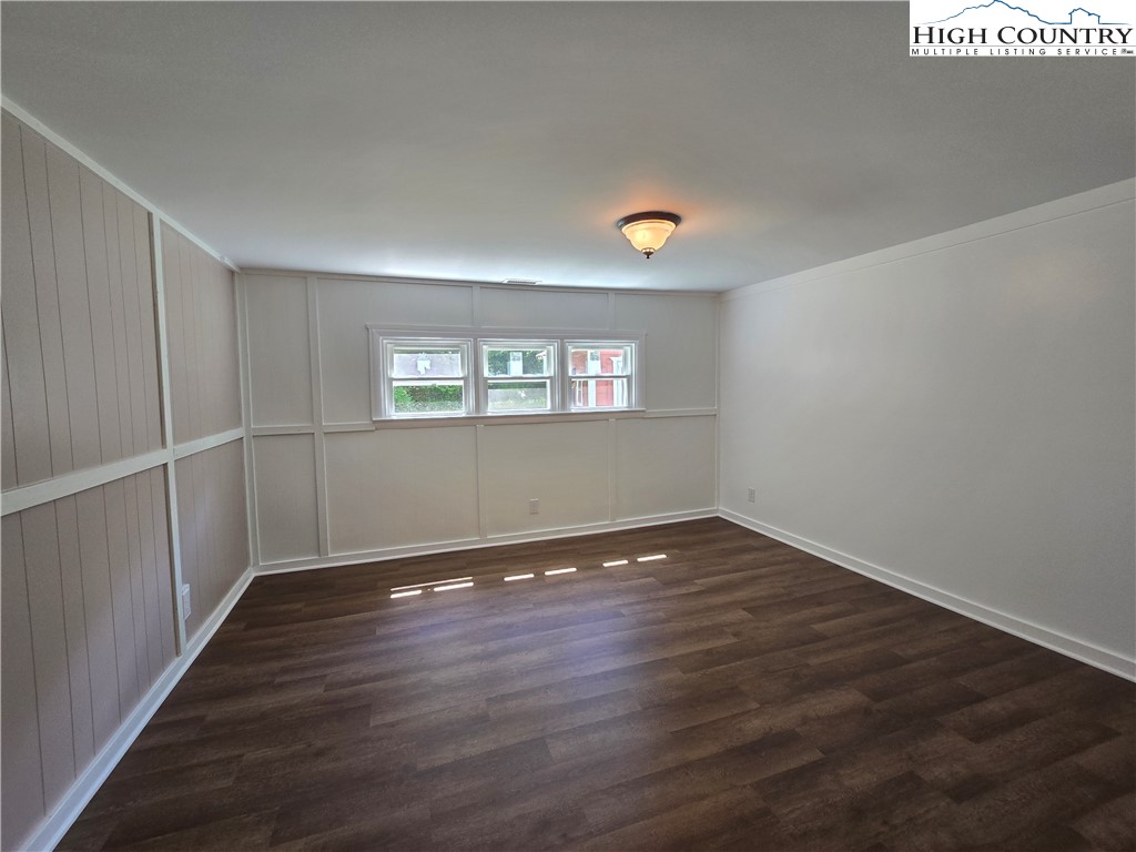 1207 Meat Camp Road Boone, NC 28607 - Photo 12 of 24 an empty room with wooden floor and windows
