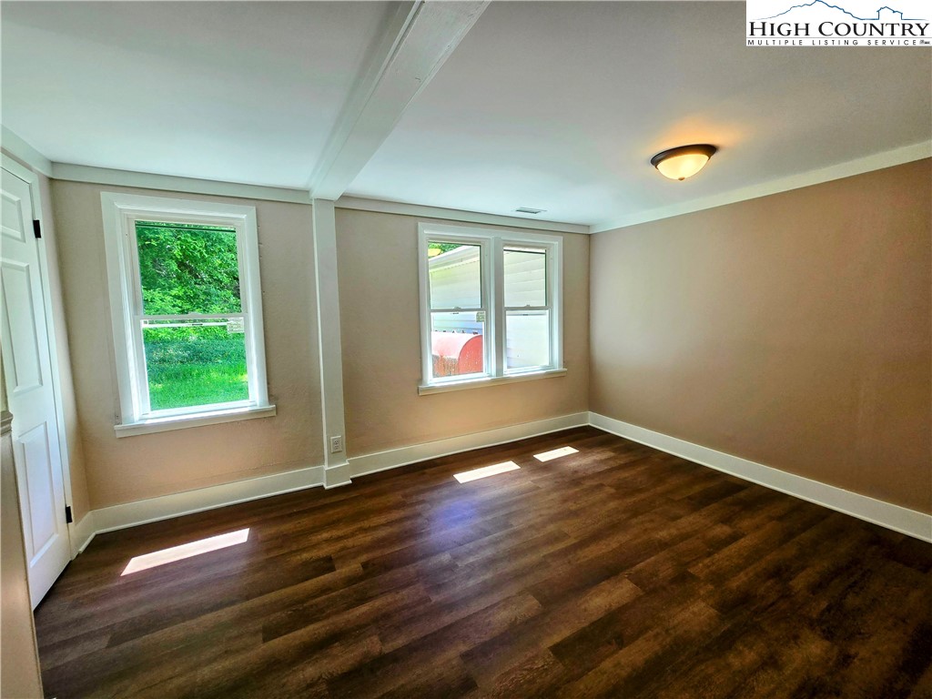 1207 Meat Camp Road Boone, NC 28607 - Photo 14 of 24 a view of an empty room with wooden floor and a window