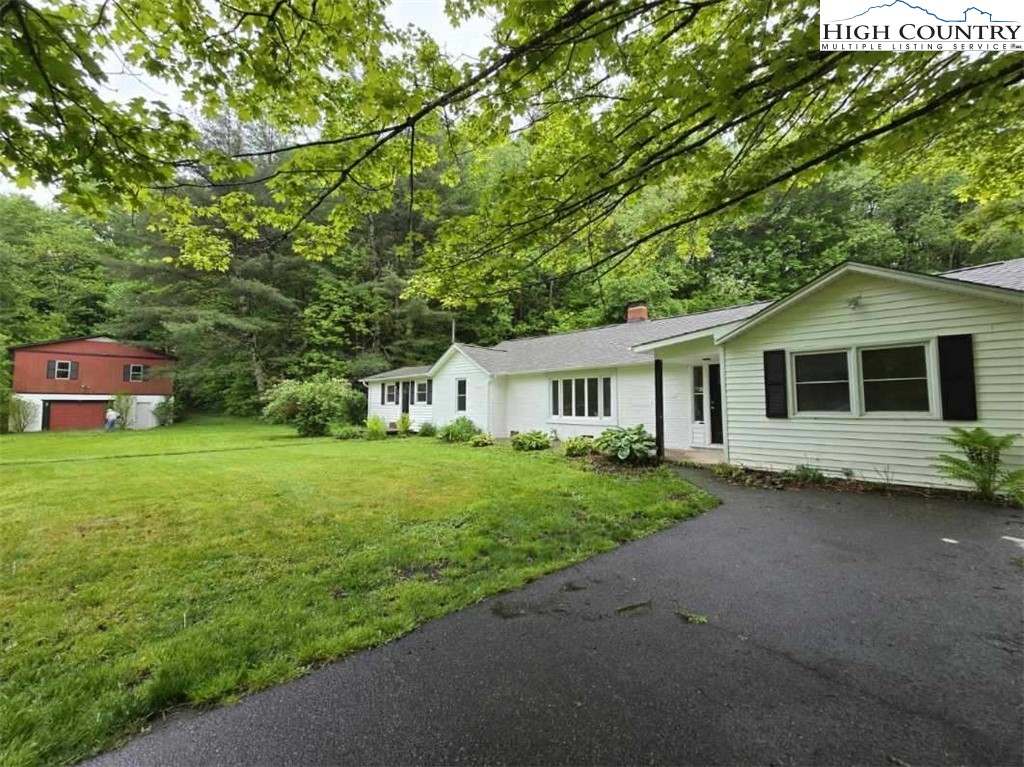 1207 Meat Camp Road Boone, NC 28607 - Photo 2 of 24 a front view of a house with a garden and trees