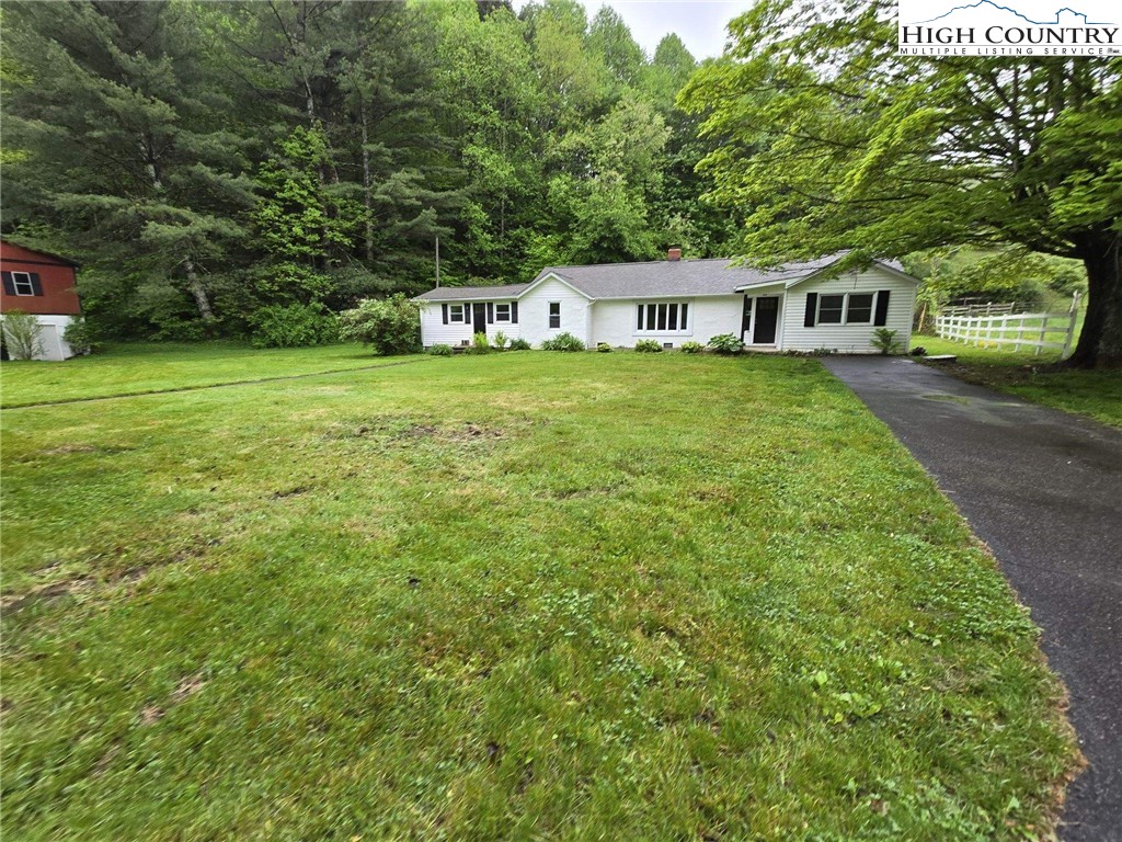 1207 Meat Camp Road Boone, NC 28607 - Photo 4 of 24 a front view of a house with garden