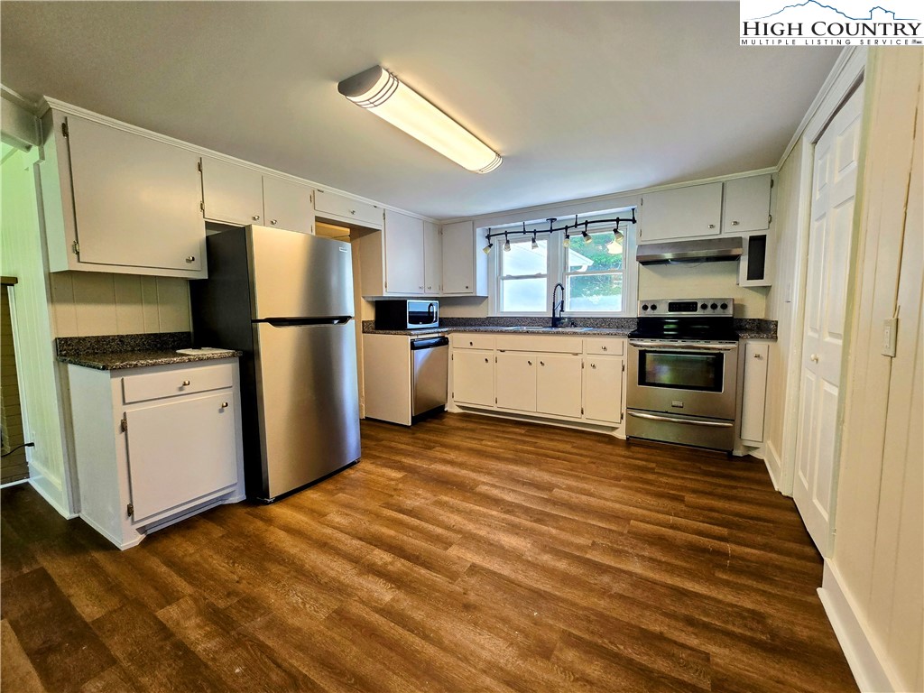 1207 Meat Camp Road Boone, NC 28607 - Photo 5 of 24 a kitchen with a refrigerator stove and microwave