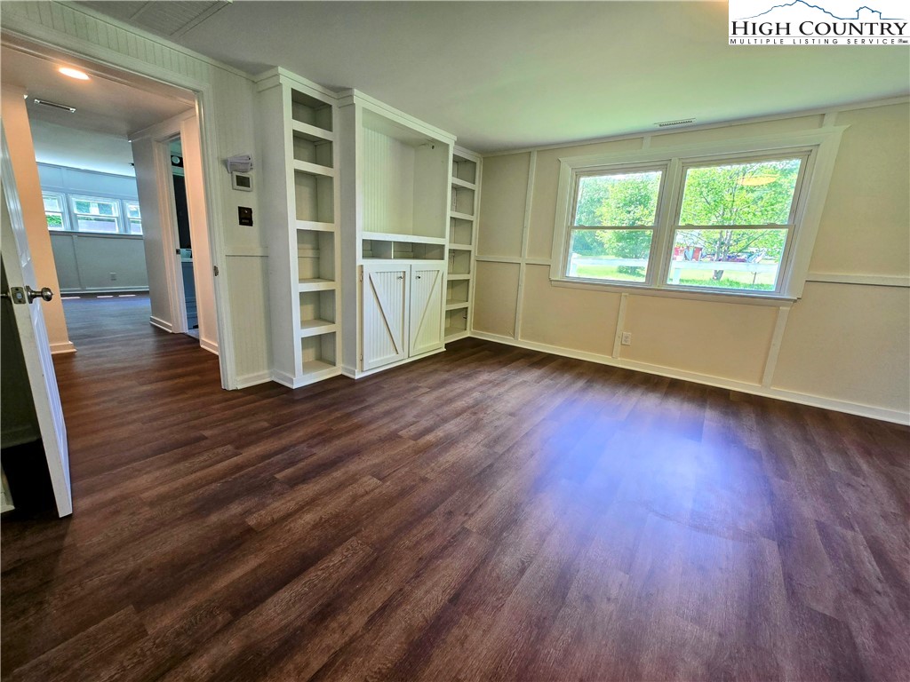 1207 Meat Camp Road Boone, NC 28607 - Photo 6 of 24 an empty room with wooden floor and windows