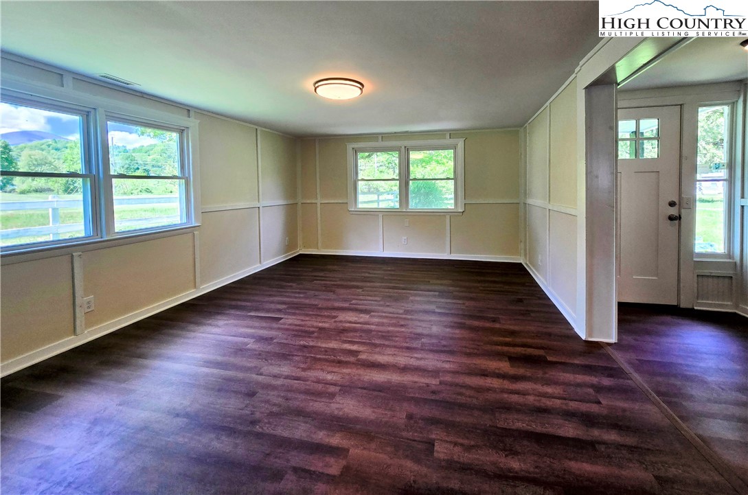 1207 Meat Camp Road Boone, NC 28607 - Photo 8 of 24 an empty room with wooden floor and windows