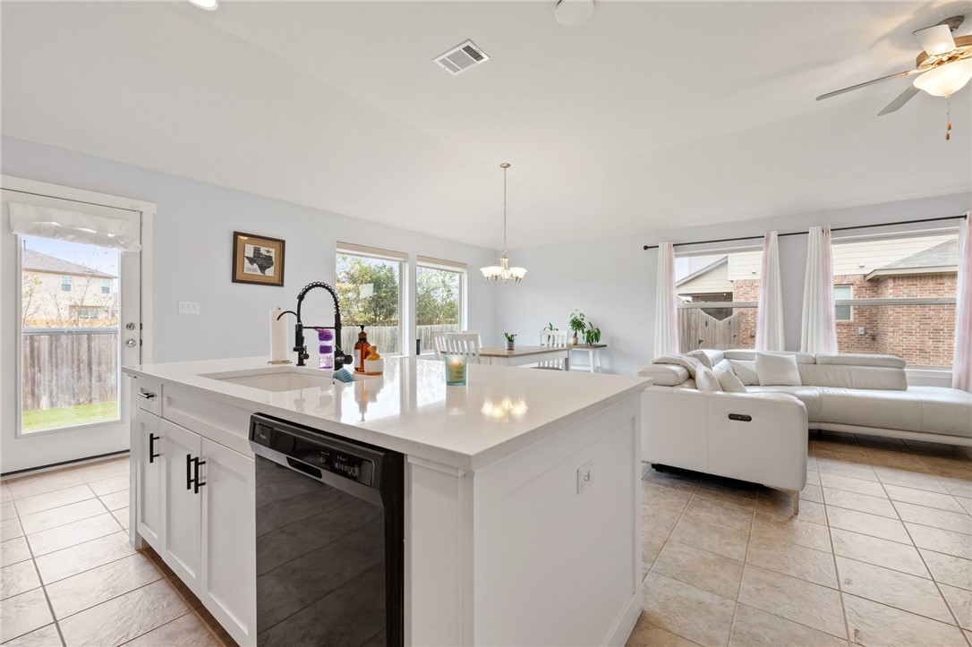 a large white kitchen with a window