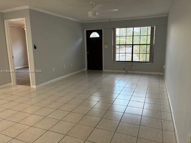 an empty room with windows and entrance