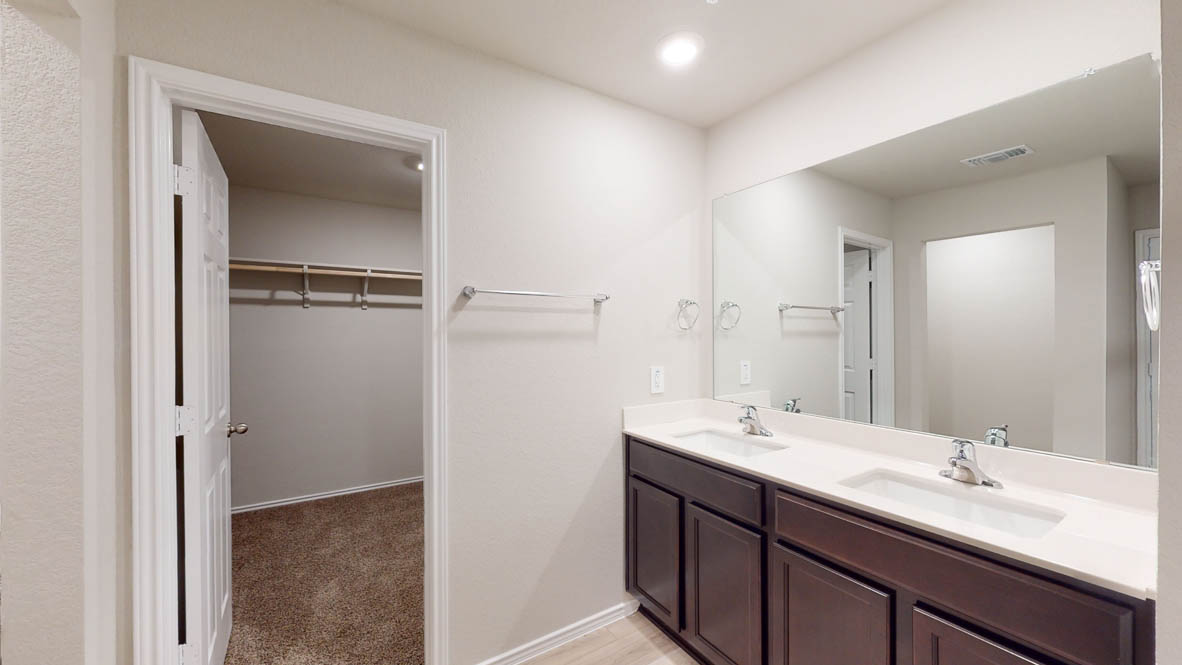 575 Hector Loop Georgetown, TX 78626 - Photo 16 of 28 Bathroom featuring a dual vanity with dark wood-finish cabinetry, white countertops, and chrome fixtures