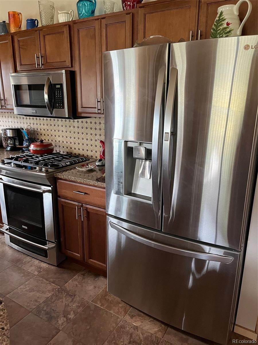 2137 Riccardo Lane Fort Garland, CO 81133 - Photo 14 of 50 a metallic refrigerator freezer sitting in a kitchen