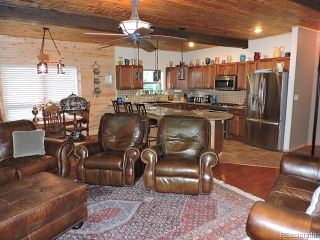 2137 Riccardo Lane Fort Garland, CO 81133 - Photo 21 of 50 a living room with lots of furniture and kitchen view