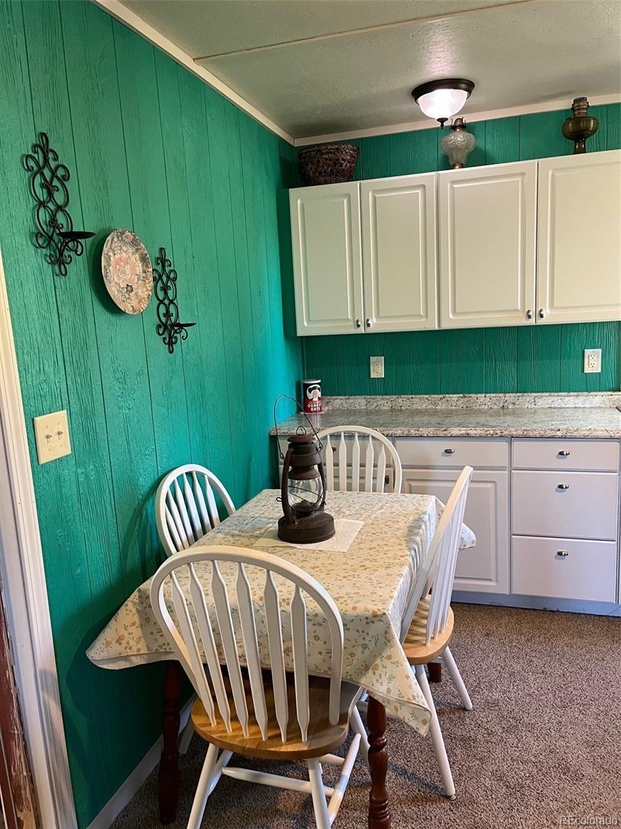 2137 Riccardo Lane Fort Garland, CO 81133 - Photo 43 of 50 a view of a dining room with furniture and wooden floor