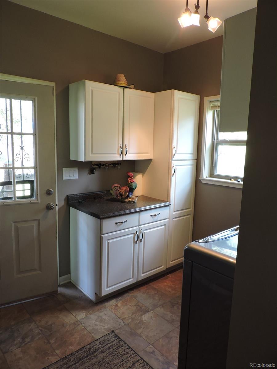 2137 Riccardo Lane Fort Garland, CO 81133 - Photo 9 of 50 a kitchen with granite countertop white cabinets and white appliances