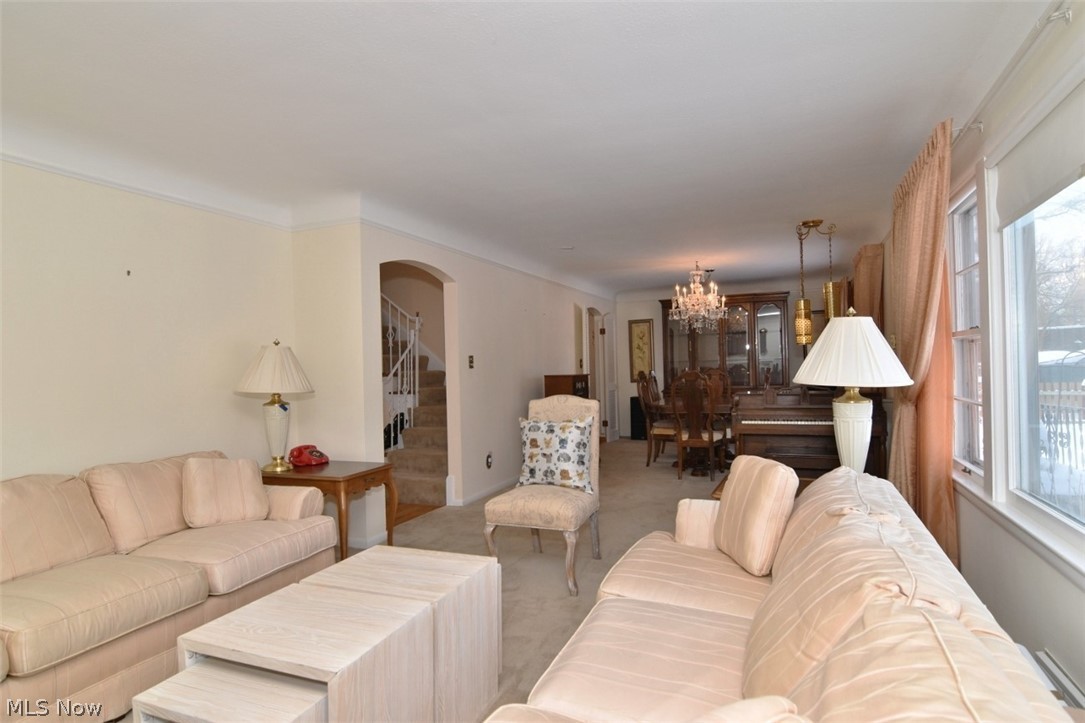 15991 Henley Road Cleveland, OH 44112 - Photo 8 of 36 Carpeted living area featuring a chandelier and fireplace