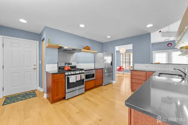 a kitchen with stainless steel appliances granite countertop a stove and a sink