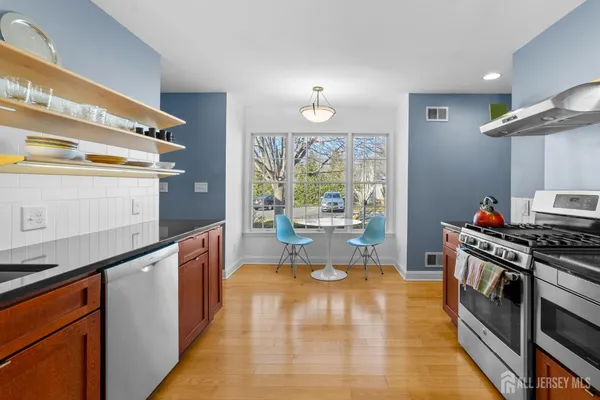 a kitchen with stainless steel appliances a stove a sink and a refrigerator
