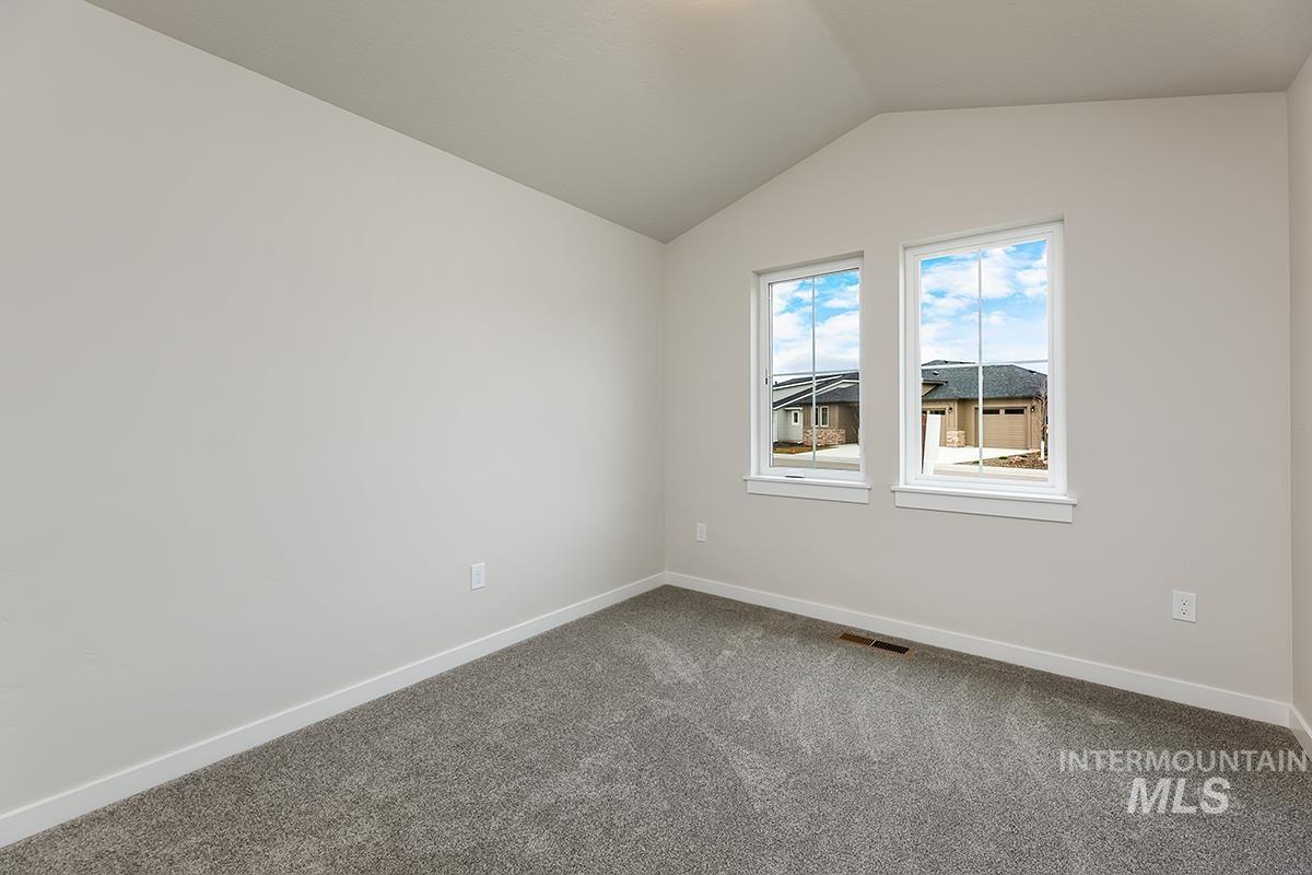 7080 South Gamely Avenue Meridian, ID 83642 - Photo 14 of 30 Unfurnished room with lofted ceiling and dark carpet