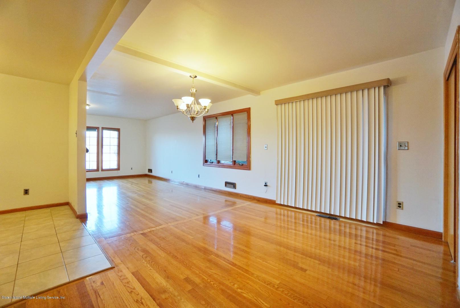 1099 Richmond Road Staten Island, NY 10304 - Photo 11 of 28 a view of a livingroom with wooden floor and a bathroom