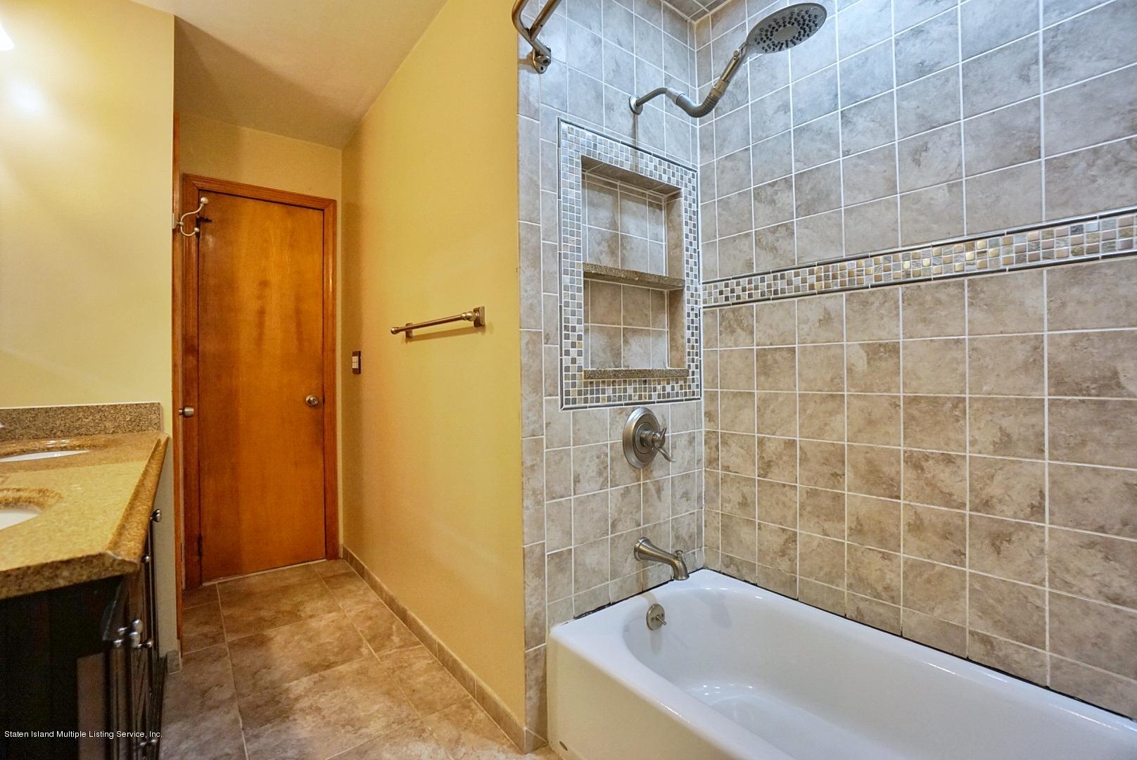 1099 Richmond Road Staten Island, NY 10304 - Photo 13 of 28 a bathroom with a bathtub and a shower
