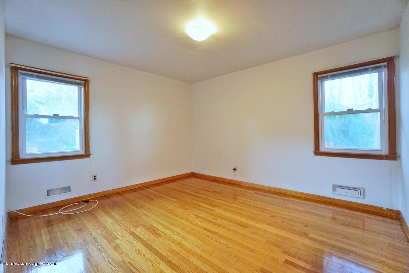 1099 Richmond Road Staten Island, NY 10304 - Photo 14 of 28 a view of an empty room with wooden floor and a window