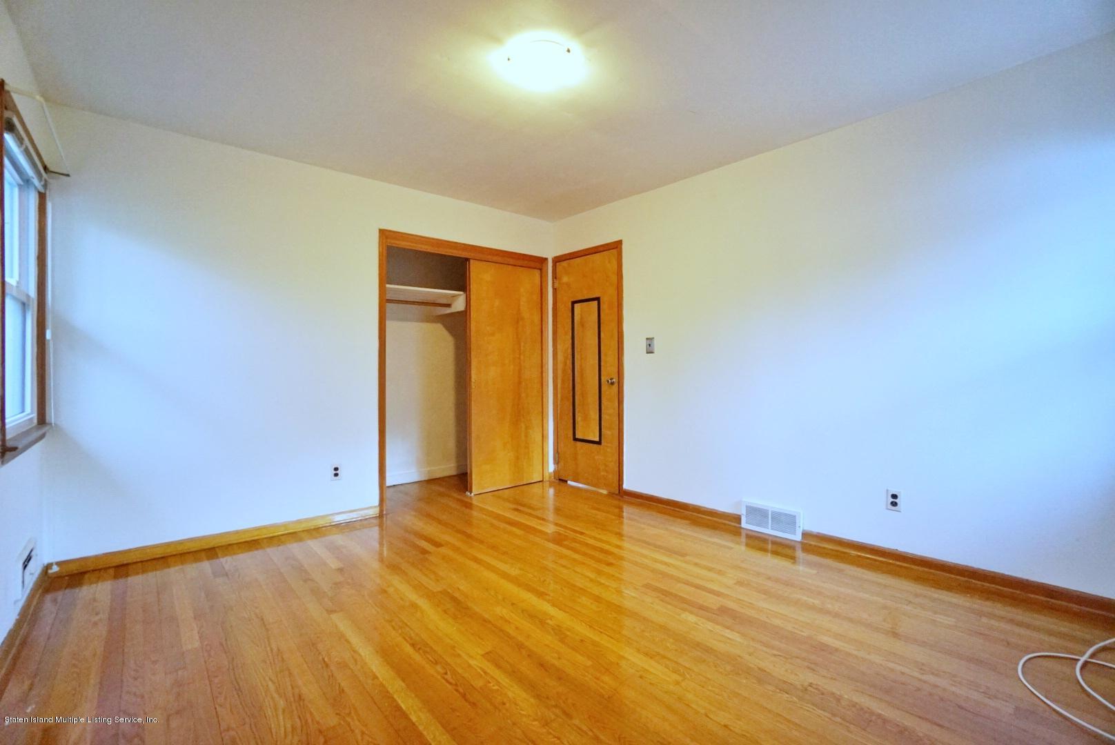 1099 Richmond Road Staten Island, NY 10304 - Photo 15 of 28 an empty room with wooden floor and closet