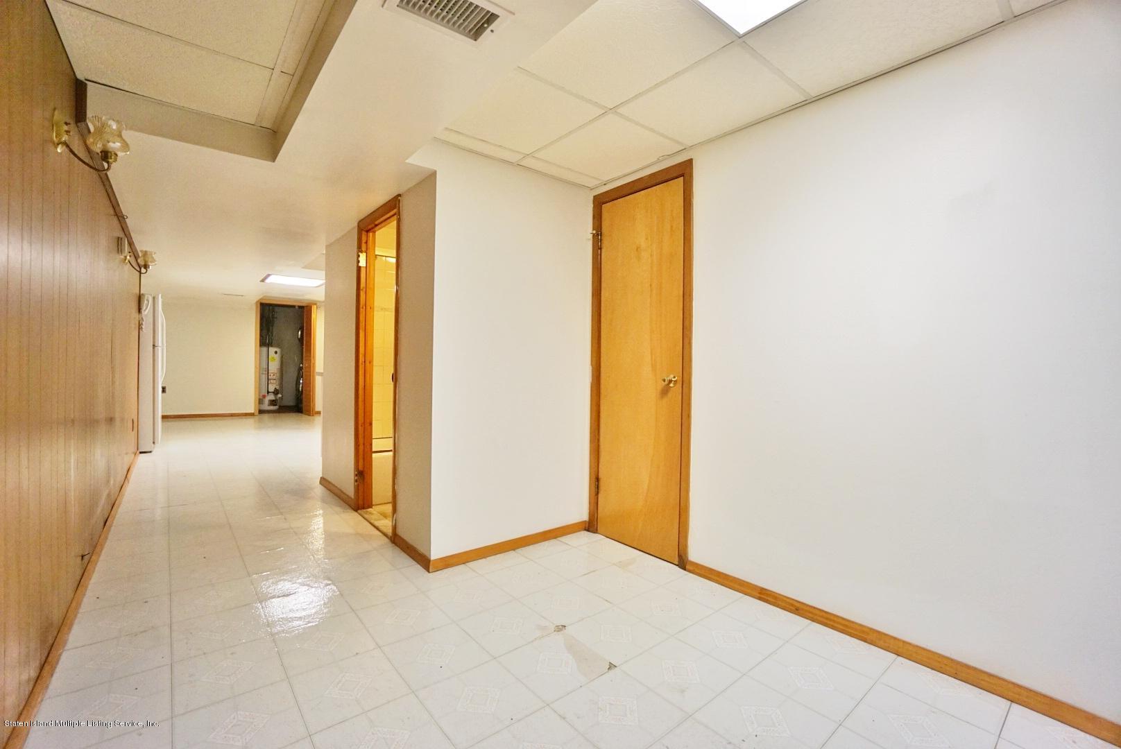 1099 Richmond Road Staten Island, NY 10304 - Photo 17 of 28 a view of a hallway with wooden shelves