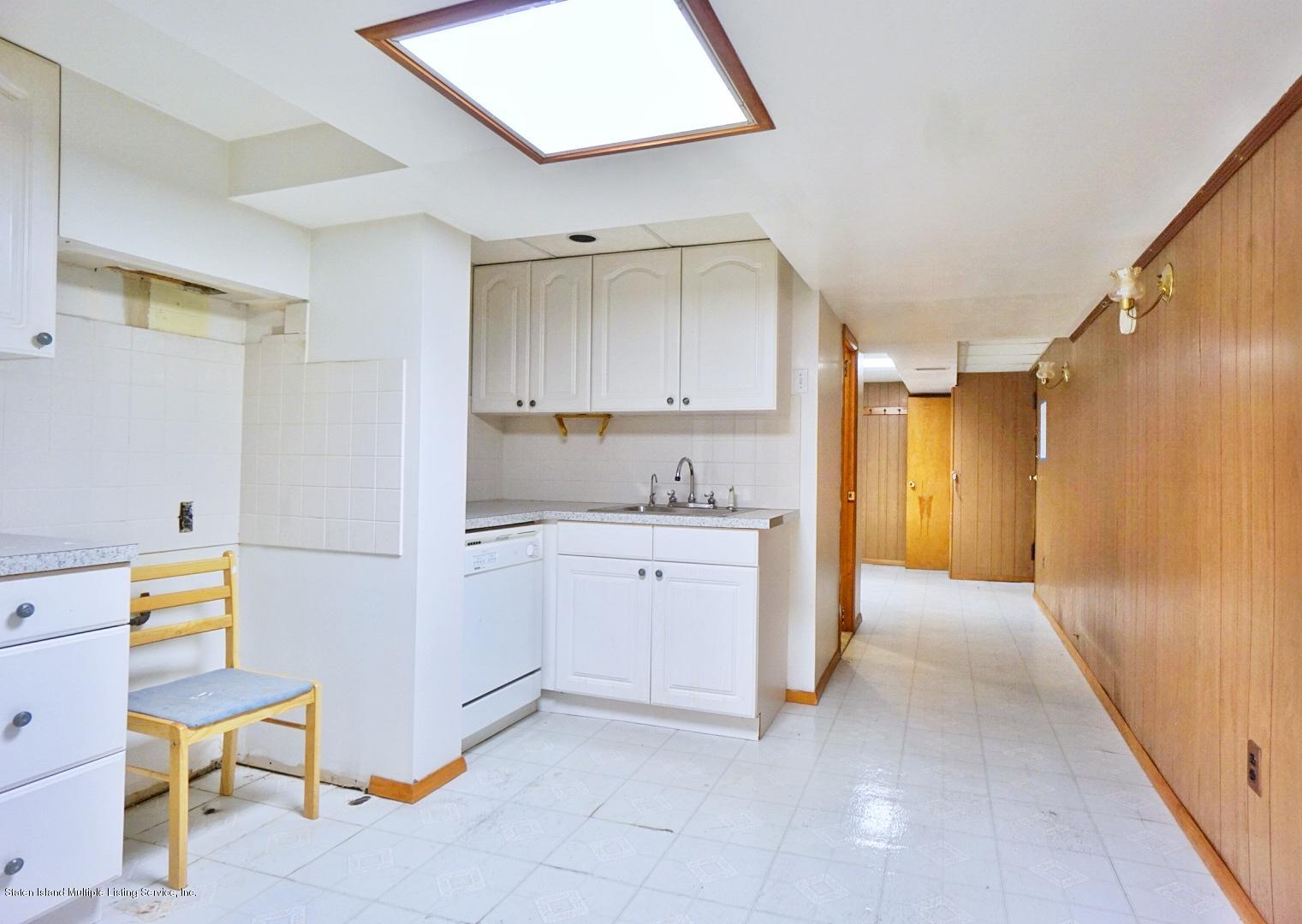 1099 Richmond Road Staten Island, NY 10304 - Photo 18 of 28 a kitchen with a refrigerator and a sink