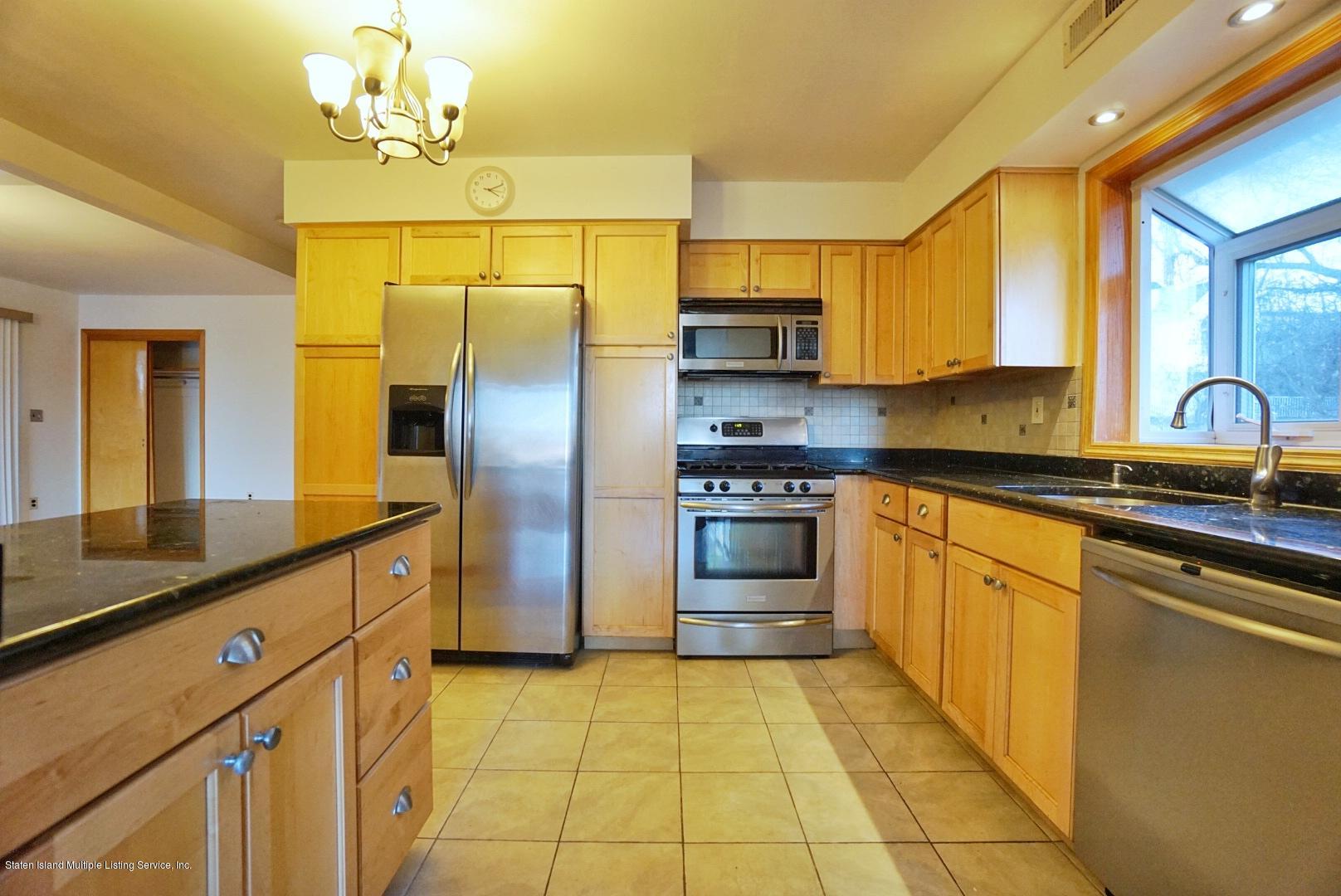 1099 Richmond Road Staten Island, NY 10304 - Photo 3 of 28 a kitchen with stainless steel appliances granite countertop a sink stove and refrigerator