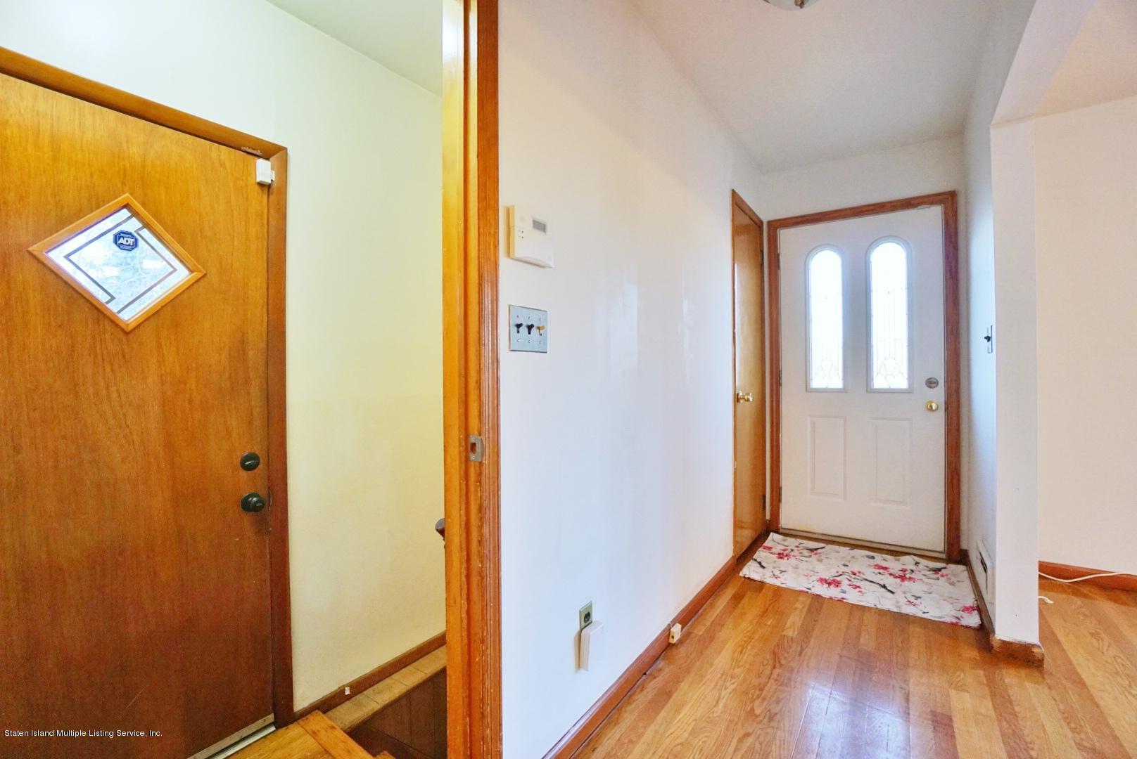1099 Richmond Road Staten Island, NY 10304 - Photo 4 of 28 a view of a hallway with wooden floor
