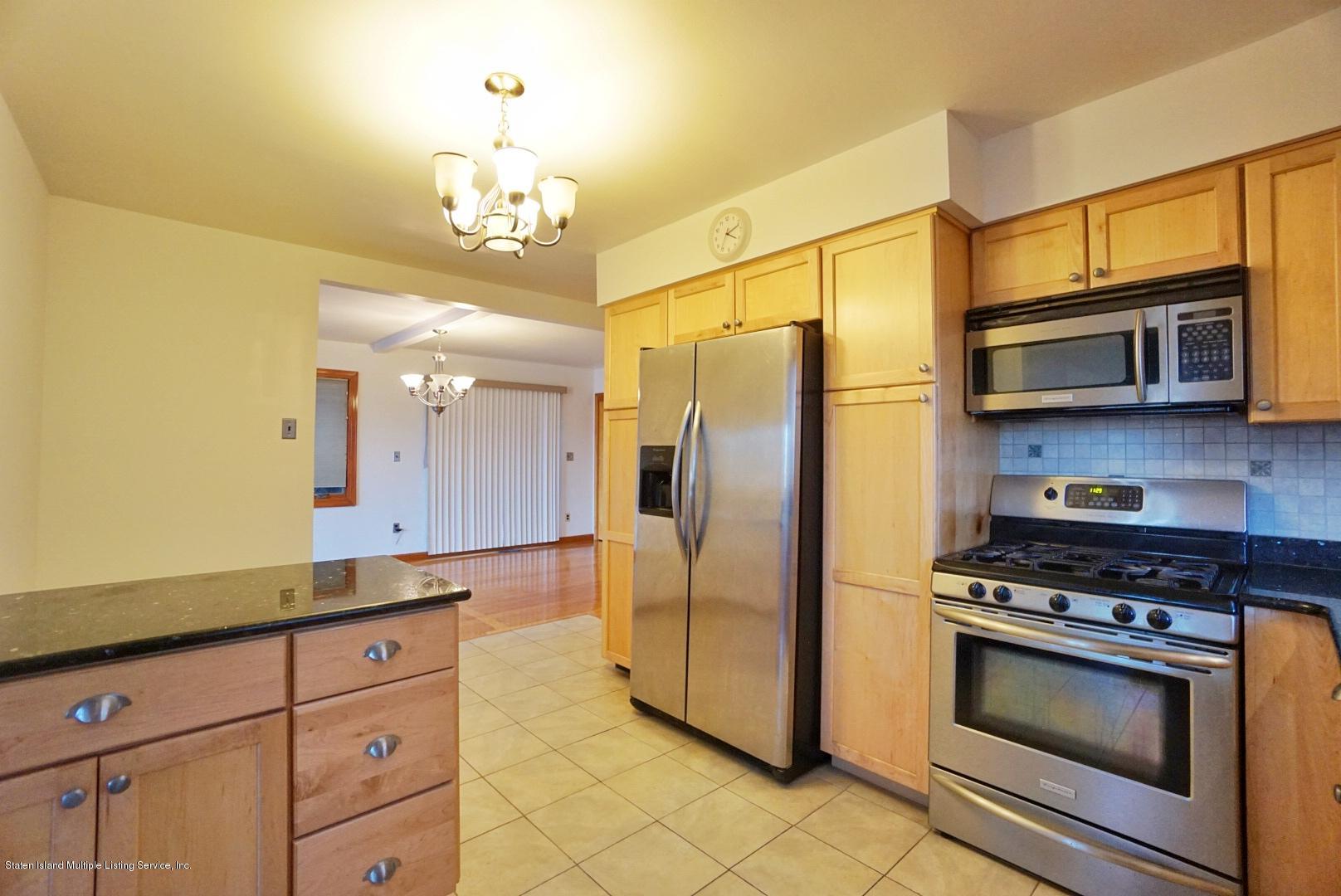 1099 Richmond Road Staten Island, NY 10304 - Photo 6 of 28 a kitchen with stainless steel appliances granite countertop a refrigerator a stove and a sink