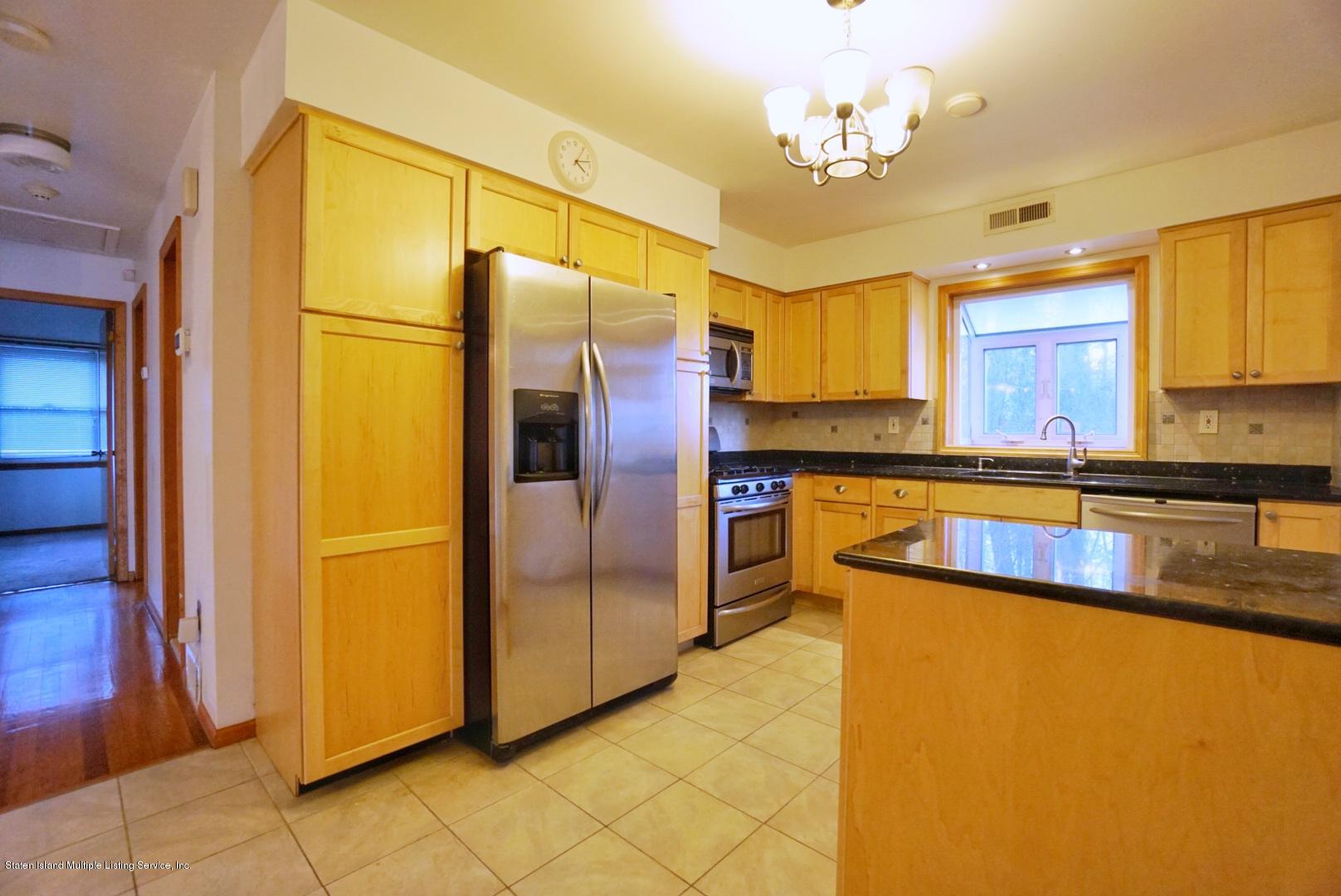 1099 Richmond Road Staten Island, NY 10304 - Photo 7 of 28 a kitchen with stainless steel appliances granite countertop a refrigerator a oven and a sink with granite countertops