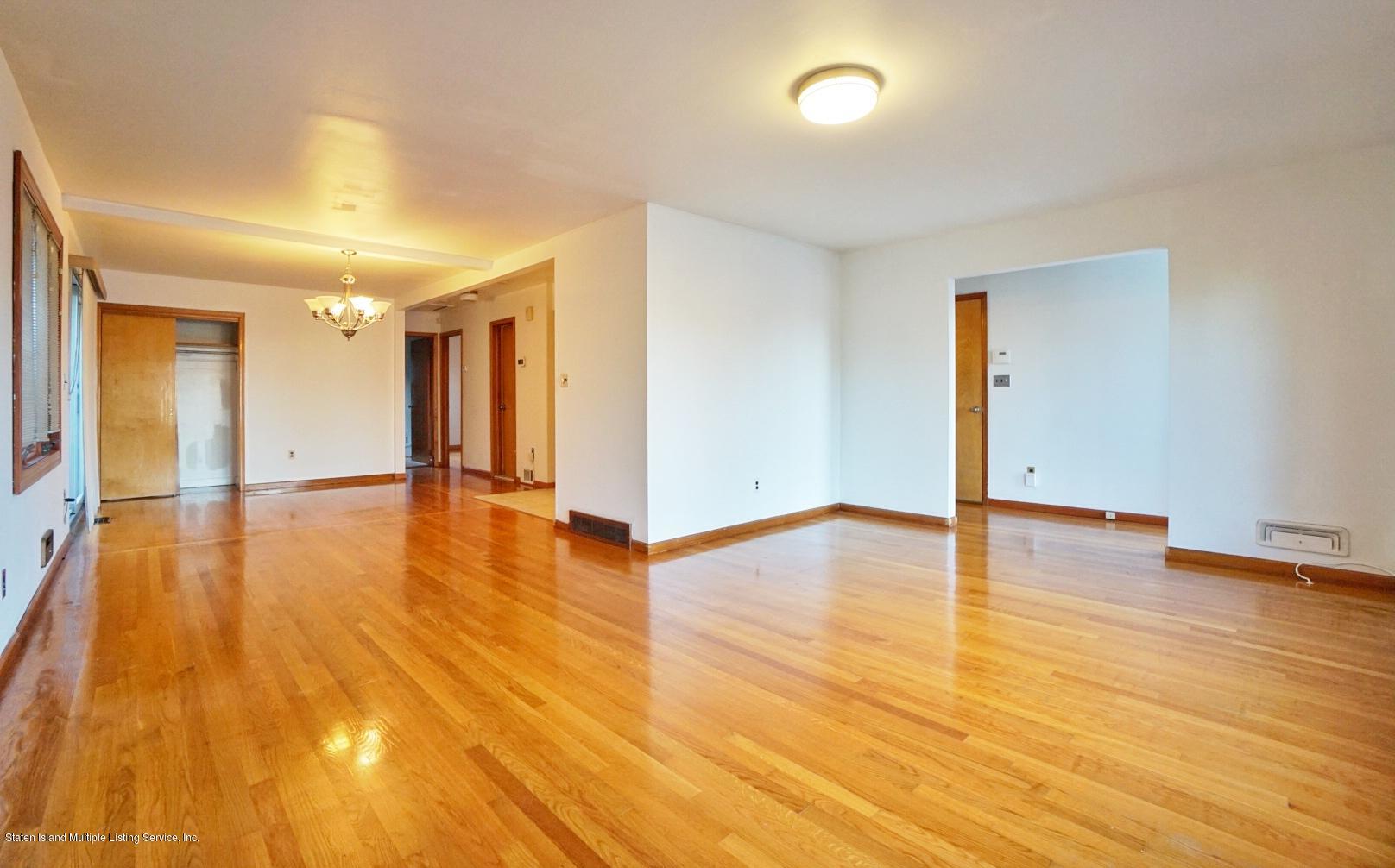 1099 Richmond Road Staten Island, NY 10304 - Photo 10 of 28 a view of an empty room and wooden floor