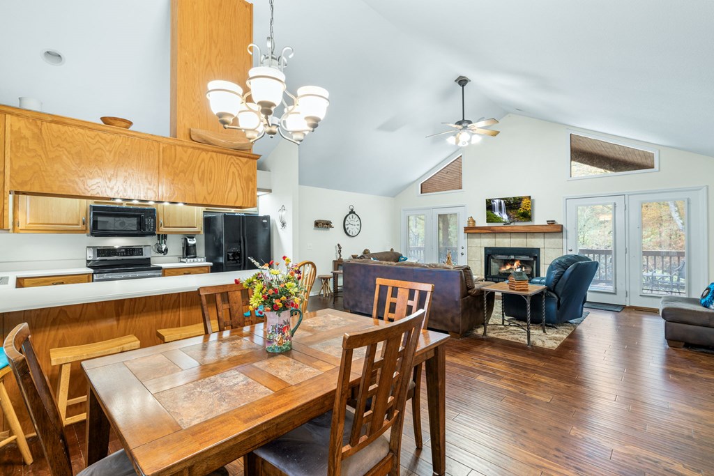 251 Rivers Edge Drive Hayesville, NC 28904 - Photo 11 of 45 a view of a dining room with furniture a chandelier and wooden floor