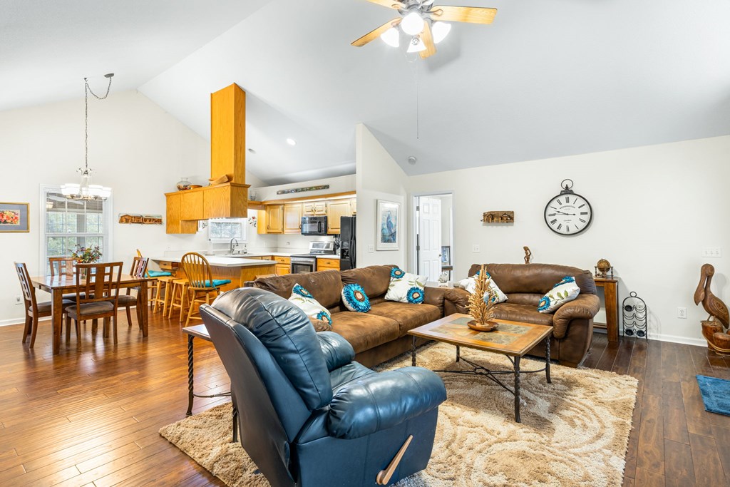 251 Rivers Edge Drive Hayesville, NC 28904 - Photo 12 of 45 a living room with furniture kitchen view and a wooden floor