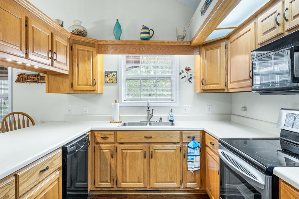 251 Rivers Edge Drive Hayesville, NC 28904 - Photo 16 of 45 a kitchen with stainless steel appliances granite countertop a sink and cabinets