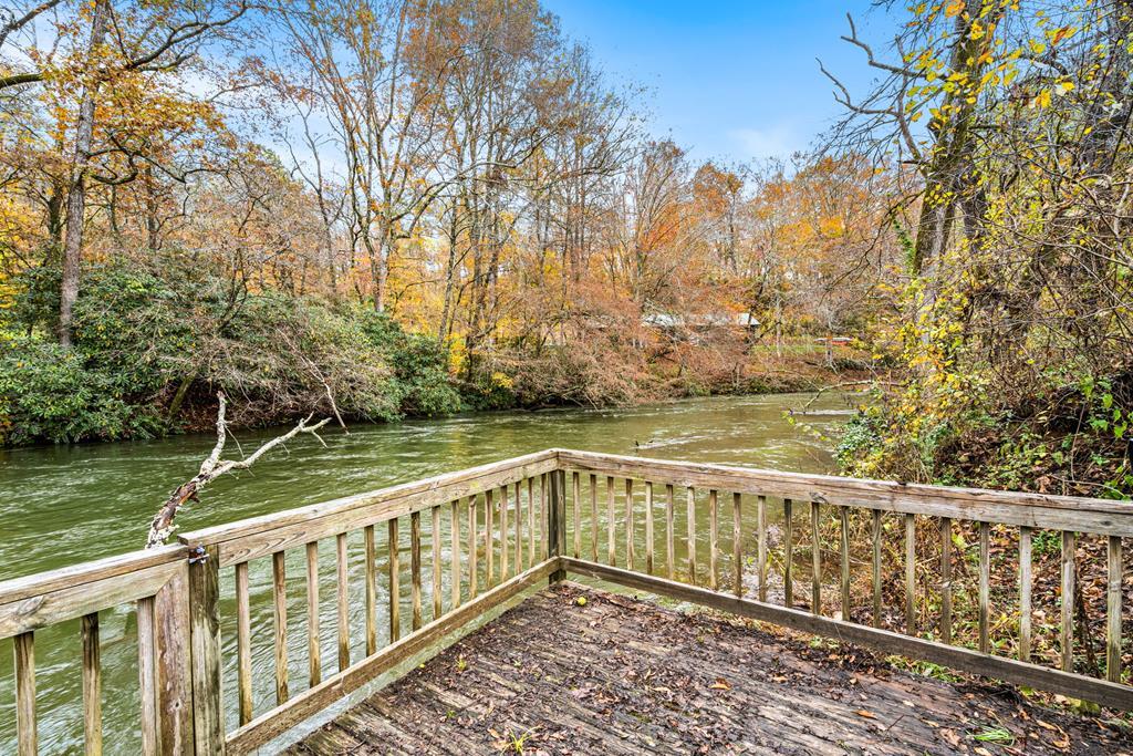 251 Rivers Edge Drive Hayesville, NC 28904 - Photo 2 of 45 a view of a wooden deck with trees in the background