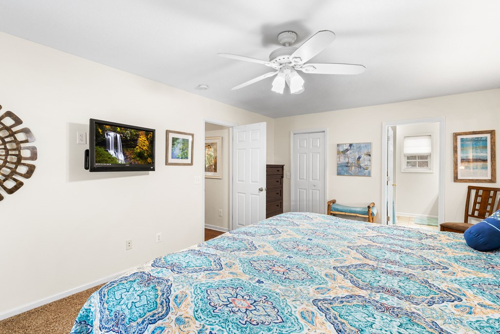 251 Rivers Edge Drive Hayesville, NC 28904 - Photo 23 of 45 a bedroom with a bed and a chandelier