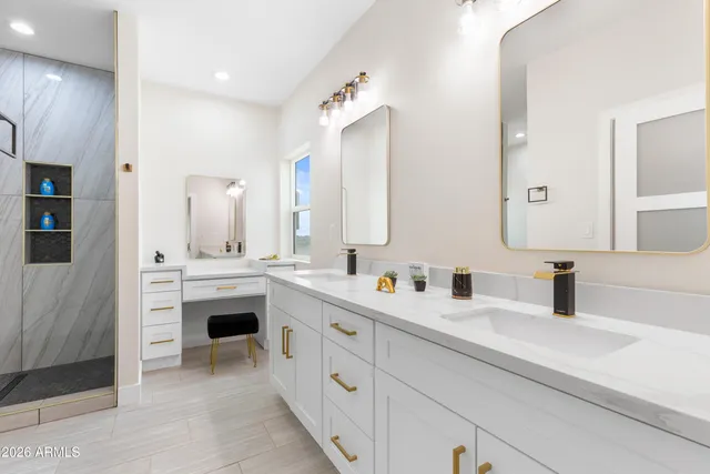 a kitchen with kitchen island granite countertop a sink a counter top space appliances and cabinets