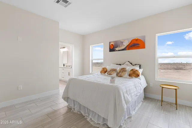 a kitchen with stainless steel appliances a refrigerator a sink a stove top oven a counter space and cabinets